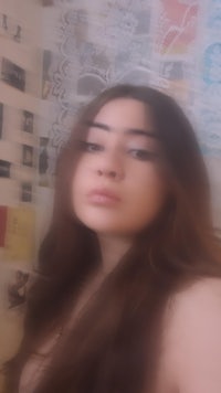 a woman is taking a selfie in front of a mirror