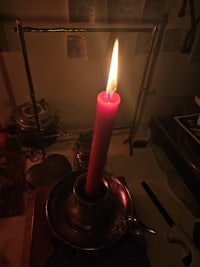 a candle is lit in a dark room